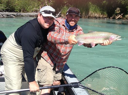 Guide holding nice 26" kenai river rainbow trout