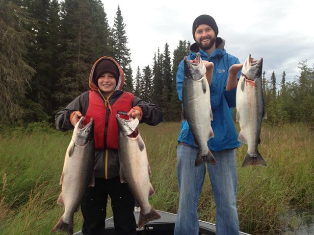 Two happy Drift Away clients holding a limit of Kenai River Silver Salmon