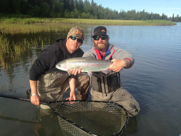 Guide holding 22" Kenai River Trout with happy client in June