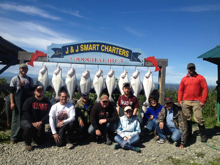 Charter posing in front of a limit of Halibut