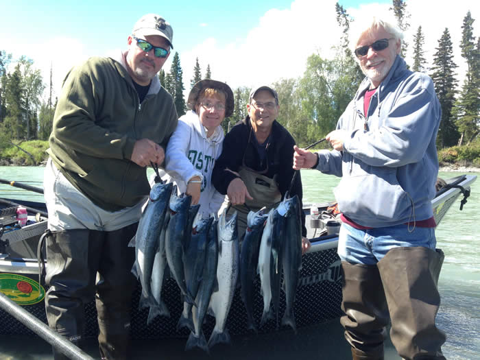 Happy anglers holding limit of Kasilof Red Salmon